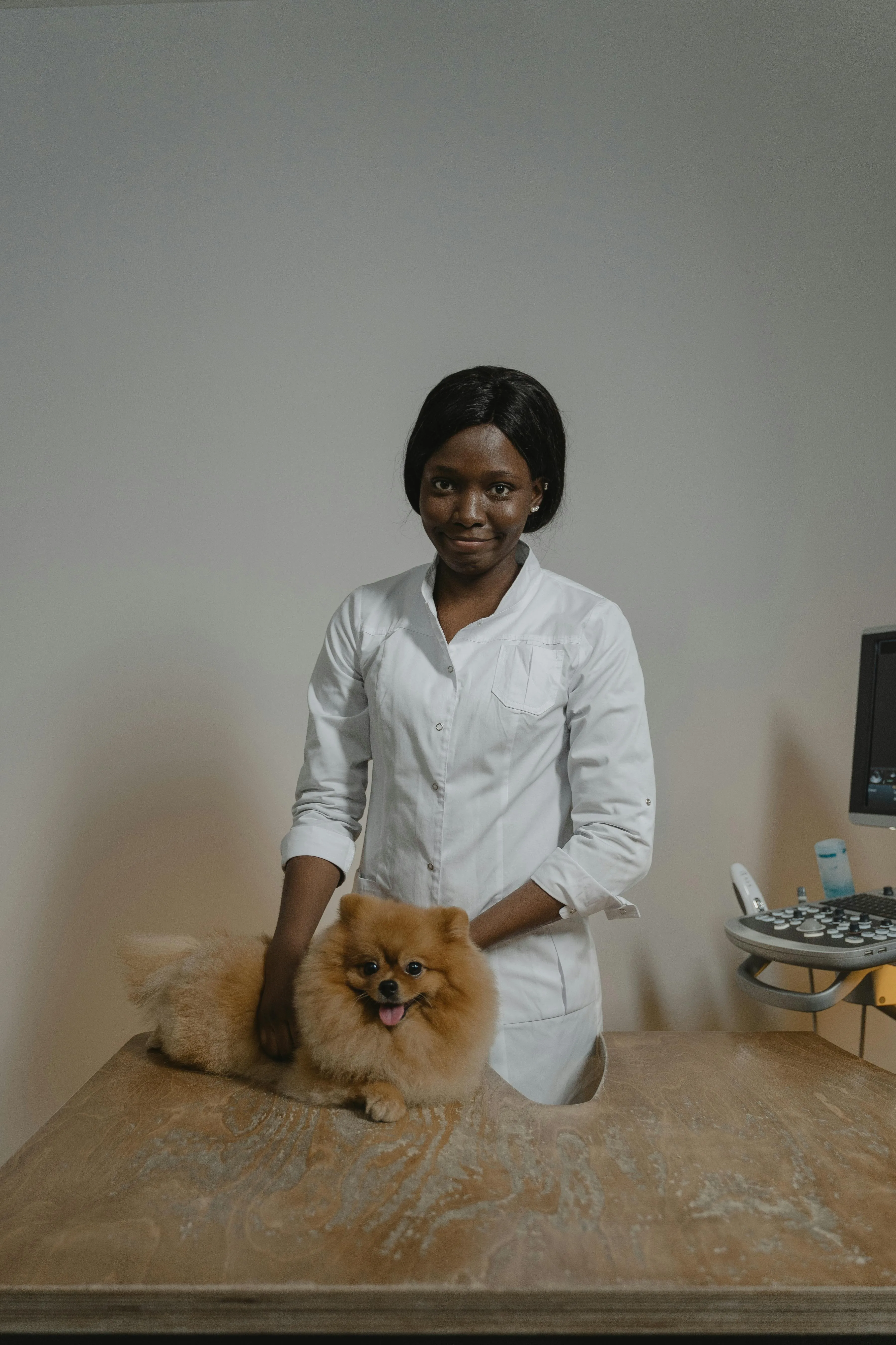 a pet caretaker wearing all white smiling while standing